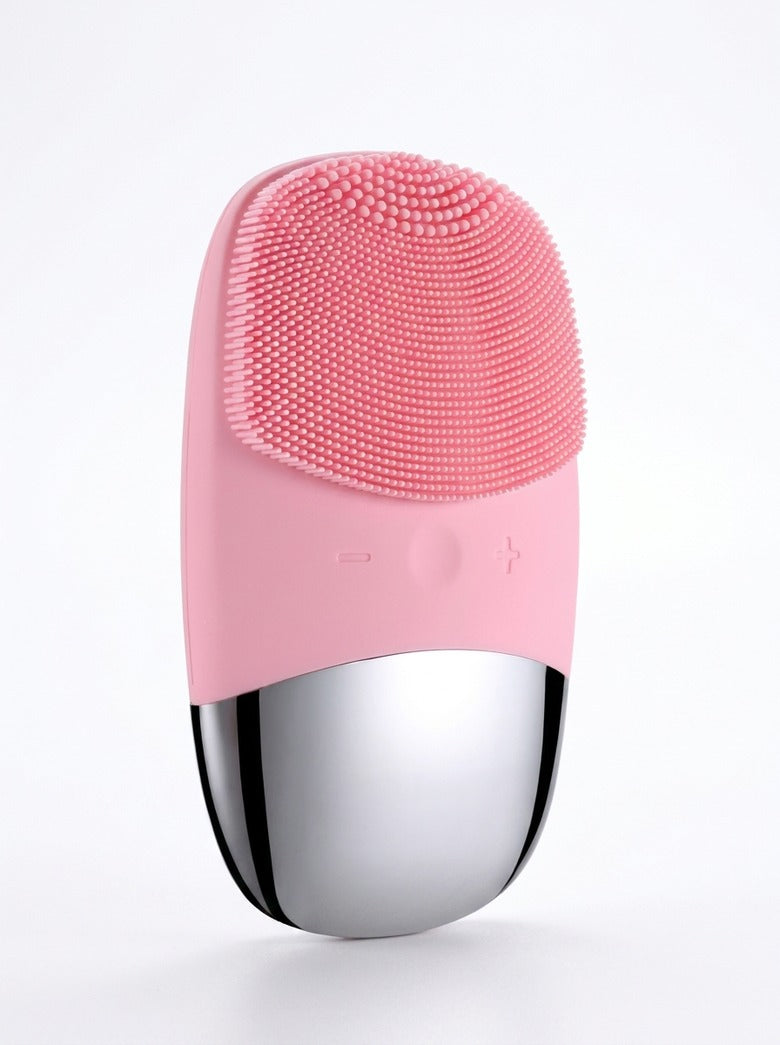 Bare pink silicone electric facial cleansing brush with polished chrome base, full product view